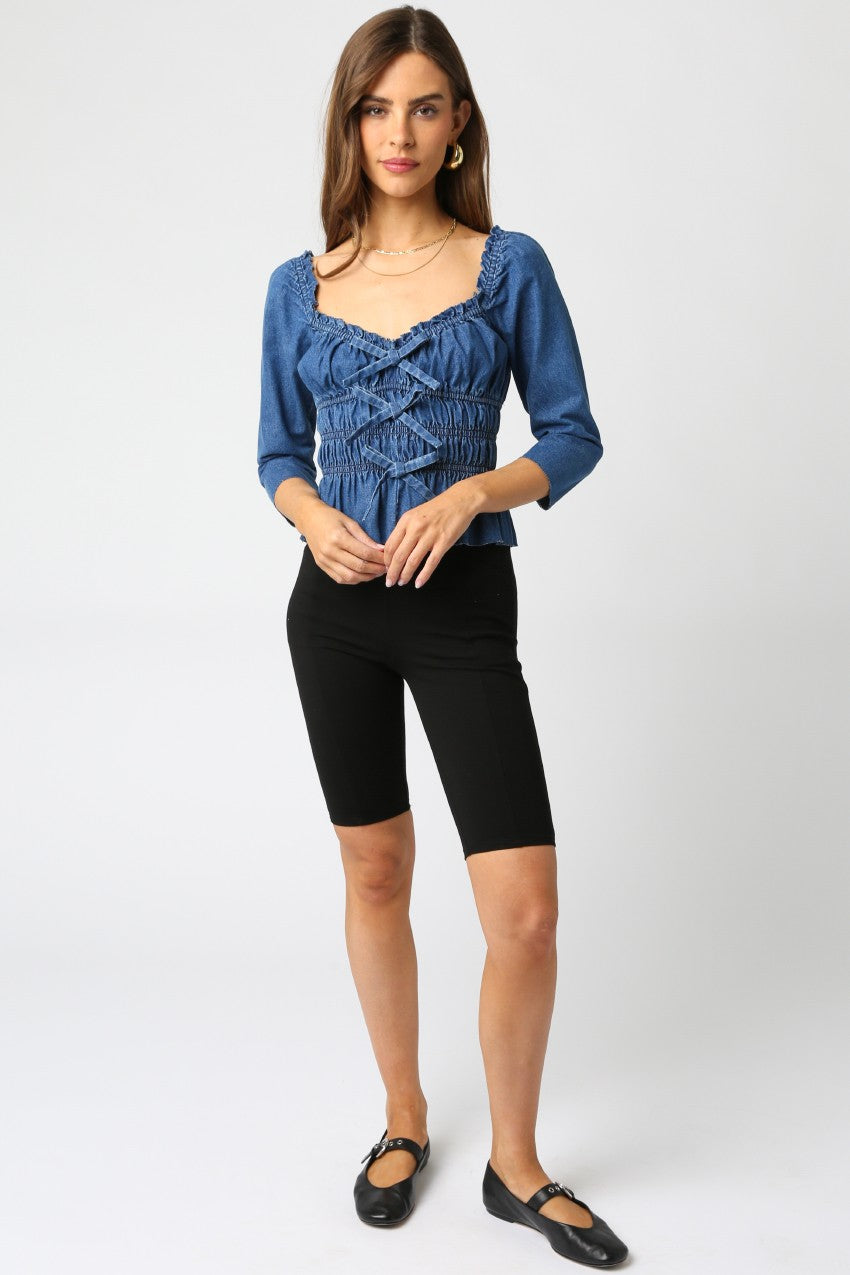 The ‘Mila Denim Ruffle Blouse’